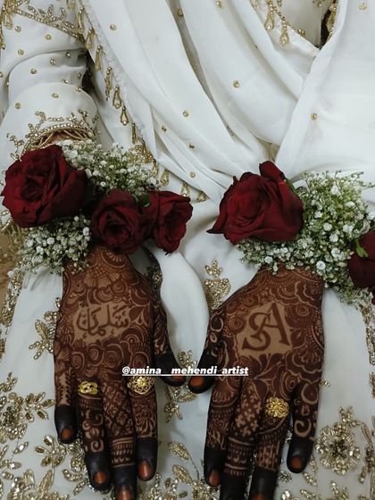 A beautiful shot of the bride's hands with personalized mehendi and floral jewelry, a perfect combination for the wedding day.