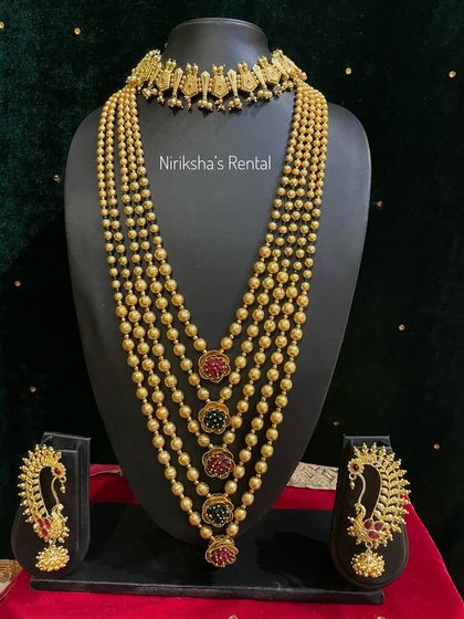 A multi-layered beaded necklace with colourful pendants, paired with a simple choker.