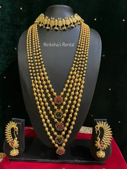 A traditional multi-layered ball chain necklace (mohan mal) with peacock earrings, a classic piece in Maharashtrian jewellery.