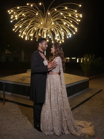 A happy, candid moment between the couple, showcasing their coordinated outfits for the sangeet.