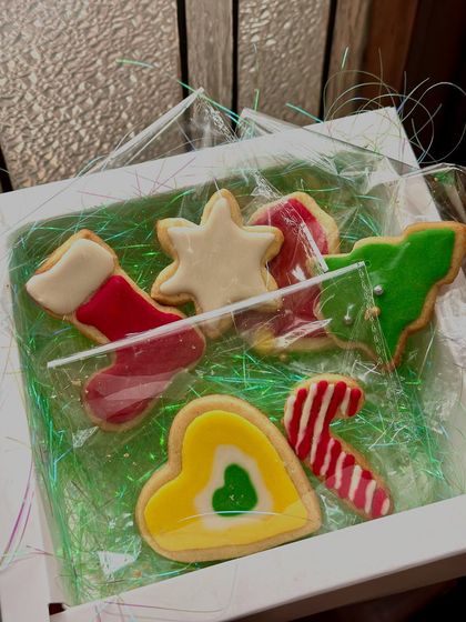 A sweet little gift box of our iced Christmas cookies. This assortment includes a stocking, a star, a candy cane, and a Christmas tree, all individually decorated and ready for gifting.