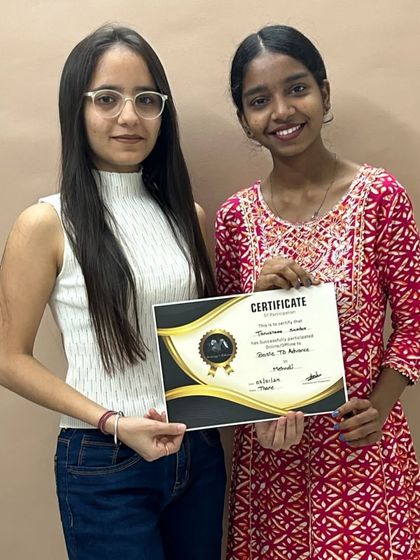 Two students proudly display their certificate after completing the comprehensive Basic to Bridal mehndi program.