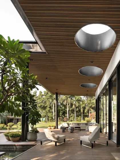 The covered deck is an essential part of the design, creating a seamless transition from the lounge to the outdoors. I incorporated large, circular skylights into the timber ceiling to draw in natural light and create playful shadows throughout the day.