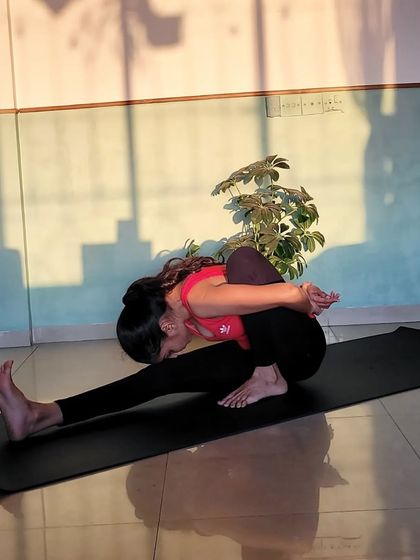 This is Marichyasana A, a deep forward fold that stretches the back and shoulders. It is a calming pose that is best practiced after your body is already warmed up.