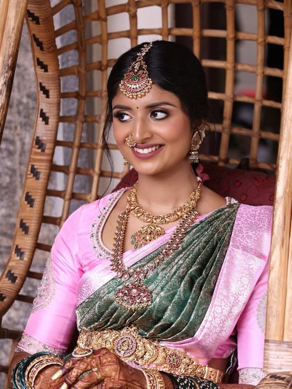 A beautiful portrait of a client for a family function. The makeup is classic and elegant, with a focus on her beautiful smile and traditional jewelry.