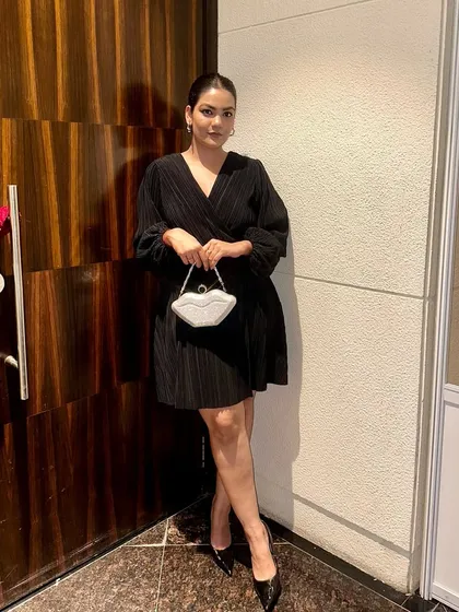 A full-length view showing how this quirky party clutch instantly elevates a simple monochrome outfit, making it ready for a night out.