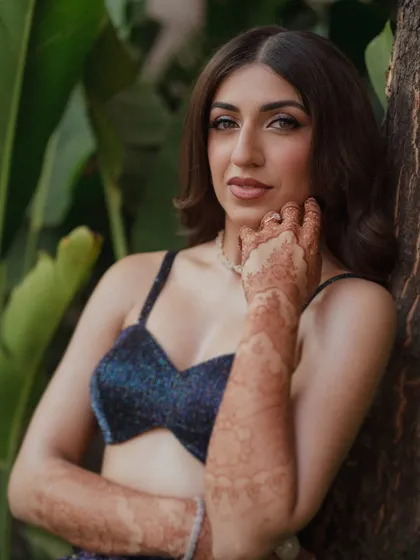 A closer look at Sheena's sangeet glam. The focus is on her sparkling eyes, achieved with soft, shimmering tones and a clean wing. It’s a look that feels dramatic yet lightweight, designed to catch the light as she dances the night away.
