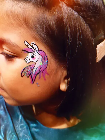 Unicorns are always a favorite. This face painting captures the magic with vibrant colors and glittery details, perfect for a fantasy themed party.