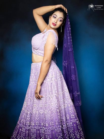 This pose shows off the full silhouette of the lehenga. The makeup was designed to be visible and impactful from afar, with defined eyes and glowing skin that stands out against the studio backdrop.