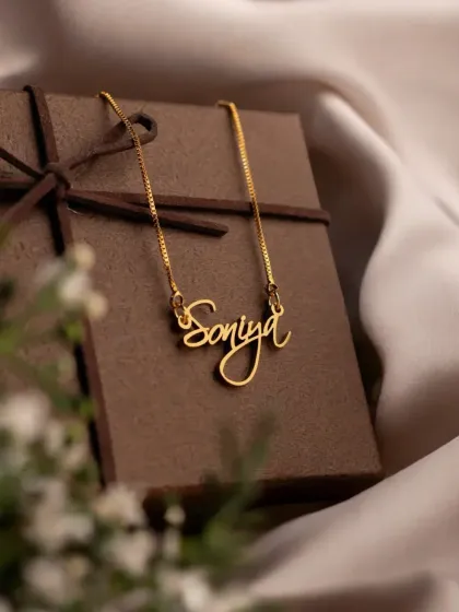 Every necklace arrives ready to make someone's day. This 'Soniya' script necklace is displayed with its elegant gift box, showing that each order is thoughtfully packaged for a perfect gifting experience.