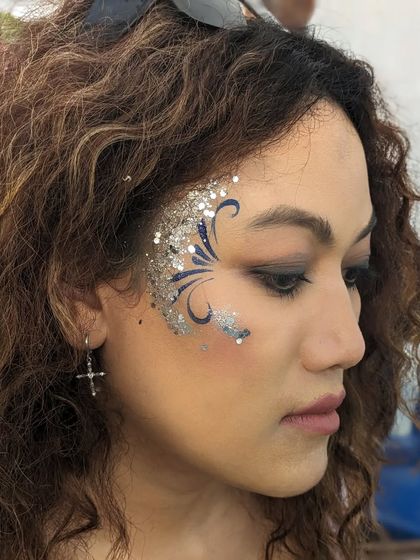 An elegant design combining blue swirls with a cascade of silver glitter.