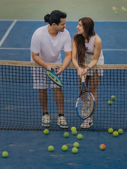 A quiet conversation by the net. Even in a playful setting, we find moments of calm connection to capture for your pre-wedding album.