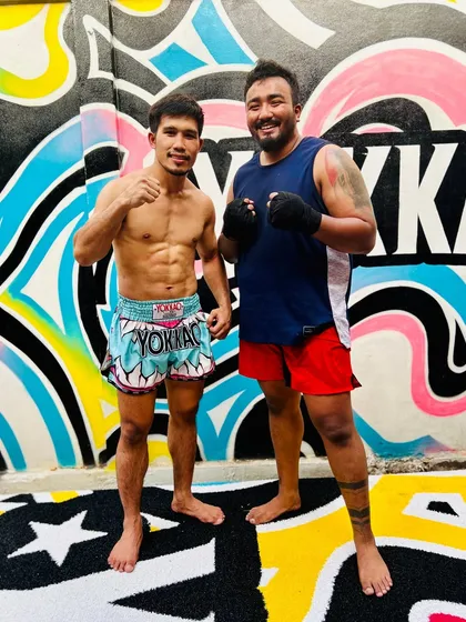 Posing with a trainer at the world-famous Yokkao gym in Thailand. I'm always a student of the game.