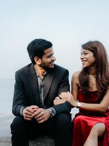 A candid moment of conversation and connection, capturing the couple's natural interaction during their pre-wedding shoot at Marine Drive.