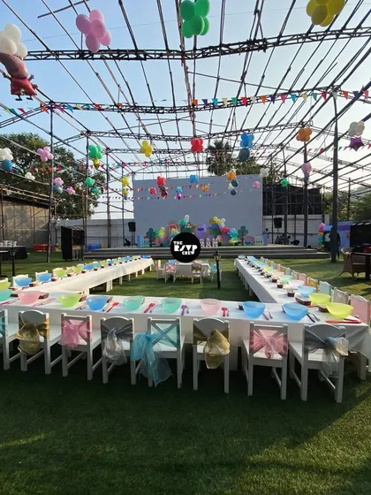A party fit for all the little guests. I arranged this large U-shaped seating area with colorful kid-sized chairs and themed tableware for an outdoor party, ensuring every child has a special spot at the table.