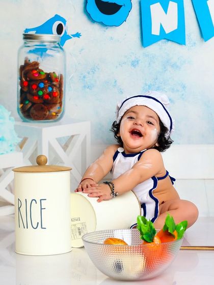 A moment of pure joy and messy fun in the kitchen. This little chef's laugh is infectious as he plays among the props.