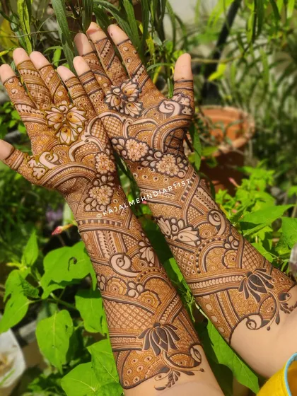 A beautiful full-coverage bridal design with a natural, leafy background that makes the henna color pop.