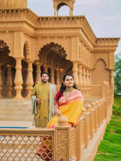 Dressed in elegant ethnic wear, this couple's pre-wedding shoot at a heritage location combines tradition with grandeur. The intricate architecture provides a timeless backdrop for their portraits.