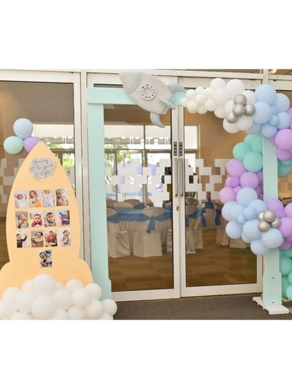 A duplicate image of the creative rocket-shaped photo display and entrance for a space party.