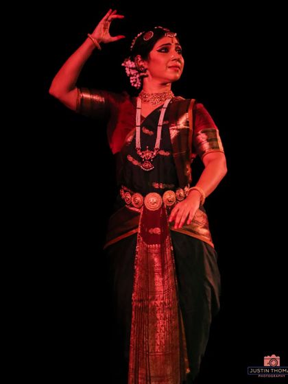 A dramatic pose under the stage lights during my solo performance. The lighting plays a crucial role in highlighting the dancer's expressions and movements.