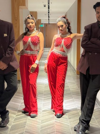 The full troupe in our striking maroon and red costumes. We pay close attention to our look to ensure it complements the theme and energy of the event.