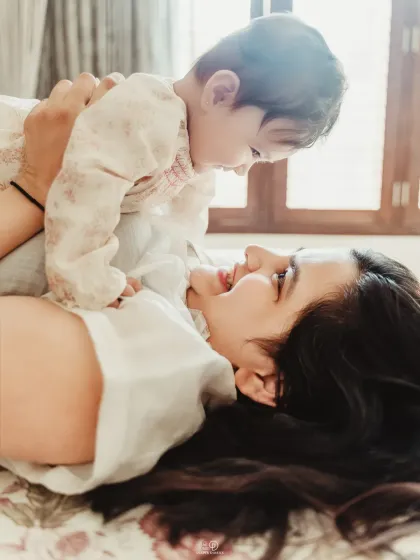 Lifting her baby up for a happy smile. These unposed, interactive moments are what make lifestyle family photography so authentic and special.