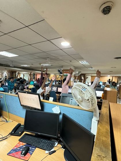 Yoga can happen anywhere, even in a busy office. Here, employees at SMC's Pratap Nagar office take a moment to stand and stretch, breaking the monotony of sitting and revitalizing their bodies and minds.