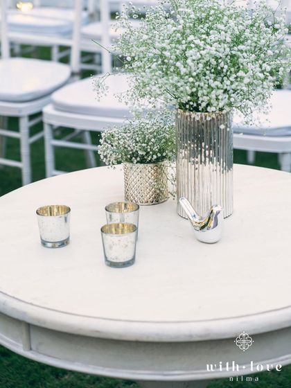 A simple yet elegant centerpiece of baby's breath in a silver vase. Sometimes, the most beautiful details are the simplest.