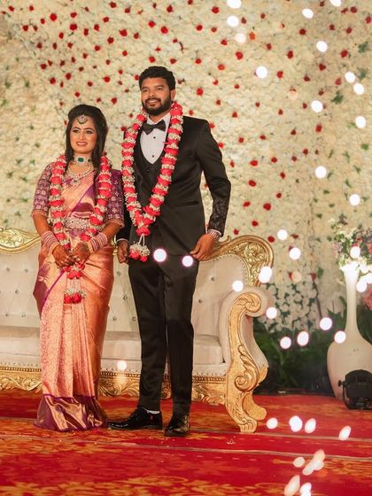 The couple on stage, ready to celebrate with their guests. Sushma's complete look is one of modern sophistication and elegance.