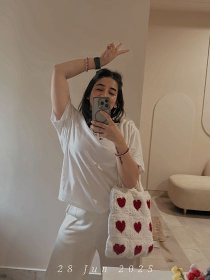Here I am, taking our heart tote bag for a spin. It’s my go-to for a casual day out, easily fitting all my essentials.