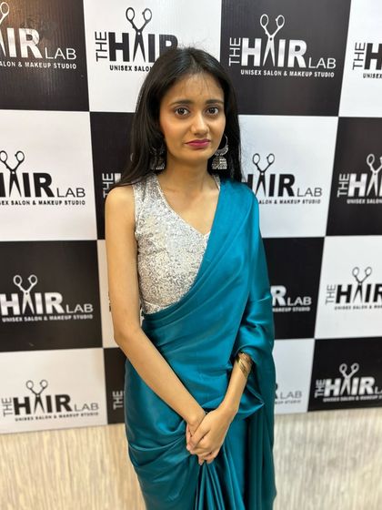 This is a great look for a cocktail party or reception. The combination of a modern sequin blouse with a satin saree is styled with clean makeup and straight hair for a chic finish.