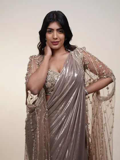 A close-up of the metallic pre-draped saree with its sheer cape, showing the delicate embroidery and beadwork.