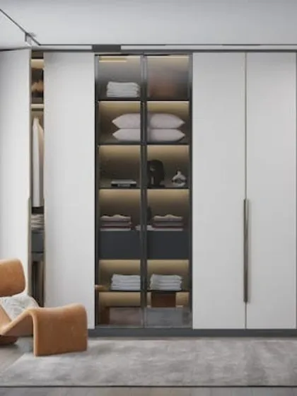 A modern take on the reach-in wardrobe, this design features a central glass display section for folded items. The clean white doors and minimalist hardware give it a contemporary and sophisticated feel.