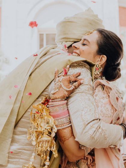A hug filled with so much joy and emotion. The bride's expression says it all as she embraces her new husband.