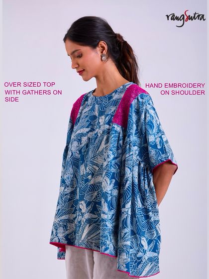 This oversized top from the Chaaya collection features gathers on the side and hand embroidery on the shoulder. It's a perfect example of a piece that doesn't cling but stays with you.