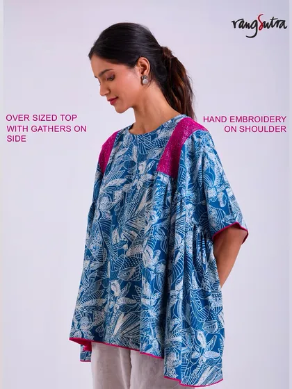 This oversized top from the Chaaya collection features gathers on the side and hand embroidery on the shoulder. It's a perfect example of a piece that doesn't cling but stays with you.