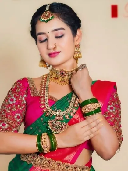 A close-up of the bride's hands, adorned with matching bangles.