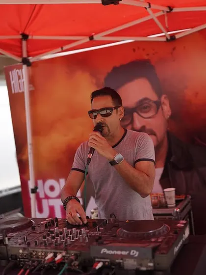 A celebrity DJ hypes up the crowd at our Holi Utsav. I book well-known artists to headline my themed parties, guaranteeing a high-quality musical experience.