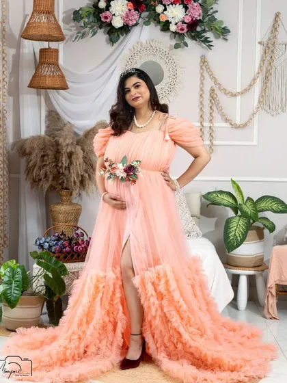 A regal pose in a peach-colored ruffled gown. The tiara adds a touch of royalty to this beautiful boho-inspired portrait.