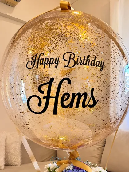 The personalized bubble balloon is the star of the show. For this "Happy Birthday Hems" gift, I filled the balloon with gold glitter to catch the light and add a festive touch.