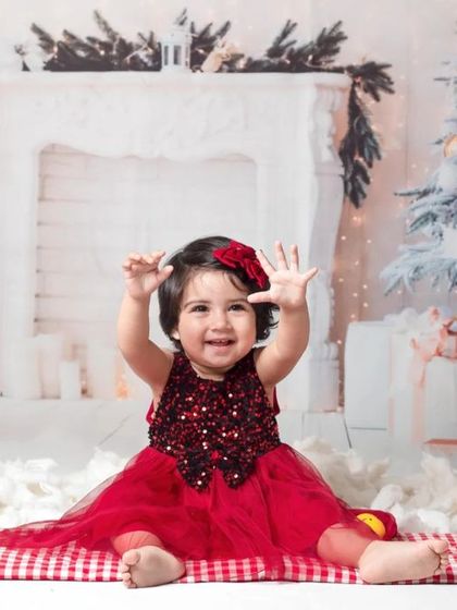 A collection of happy kids enjoying my two distinct Christmas setups: a bright, snowy winter scene and a warm, rustic brick fireplace.