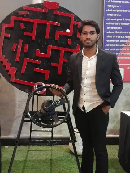 The Maze Runner game, where players use a steering wheel to navigate a ball through a large vertical maze. It's a challenging game of skill for one or two players.