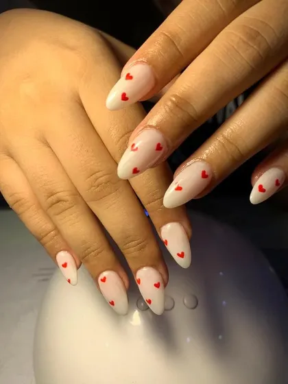 A sweet and simple design with a milky white base and tiny, hand-painted red hearts.