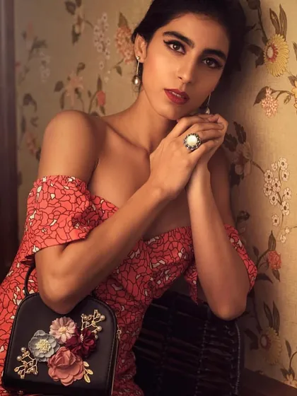 Another shot of the vintage floral dress, this time accessorized with a unique floral bag. This shows my attention to detail in ensuring every element of the outfit tells a cohesive story.