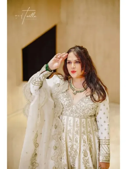 A fun and confident pose from the bride. This shot captures her playful personality and adds a unique touch to her portrait series.