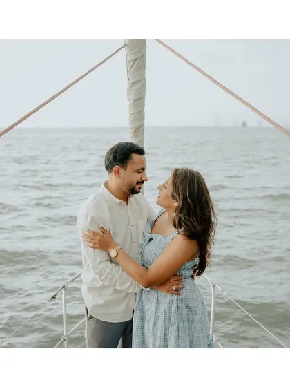 A classic romantic pose on the bow of a yacht, with the endless sea creating a beautiful, clean backdrop.
