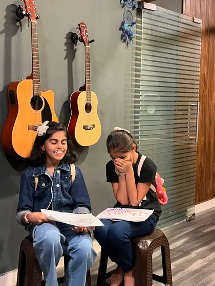 A moment of pure joy and friendship during a kids' music session. We focus on creating a comfortable space where children feel free to express themselves and have fun.
