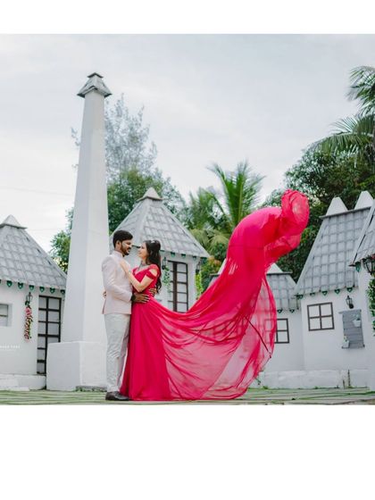 A fairytale setting for a fairytale romance. This pre-wedding photo, featuring a flowing magenta gown, looks like a scene from a storybook.
