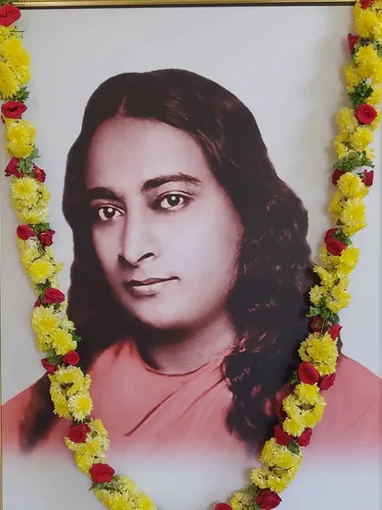 A portrait of our guru, Paramhansa Yogananda, garlanded with flowers. His teachings are the bedrock of our path, and his love is our constant guide and inspiration.