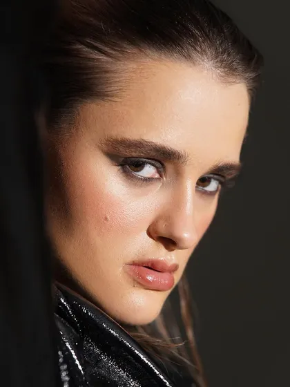 A close-up on a dramatic, dark smokey eye. The blending is seamless, creating a look that is intense, mysterious, and full of attitude.